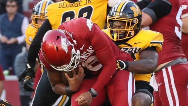 Missouri linebacker Brayshawn Little John brings down Arkansas quarterback Jacolby Criswell.